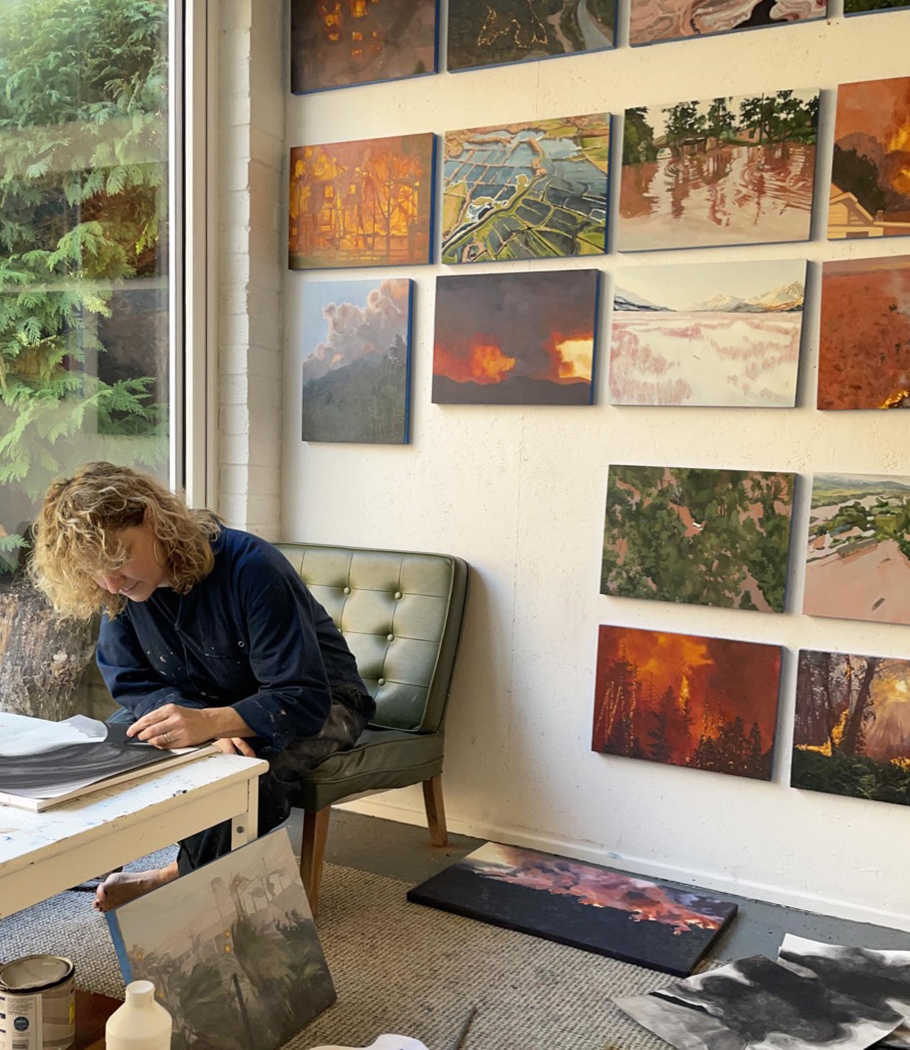 me in studio 2022 Painting of a small child standing in a wood of autumn colours, an old shack off to the right.